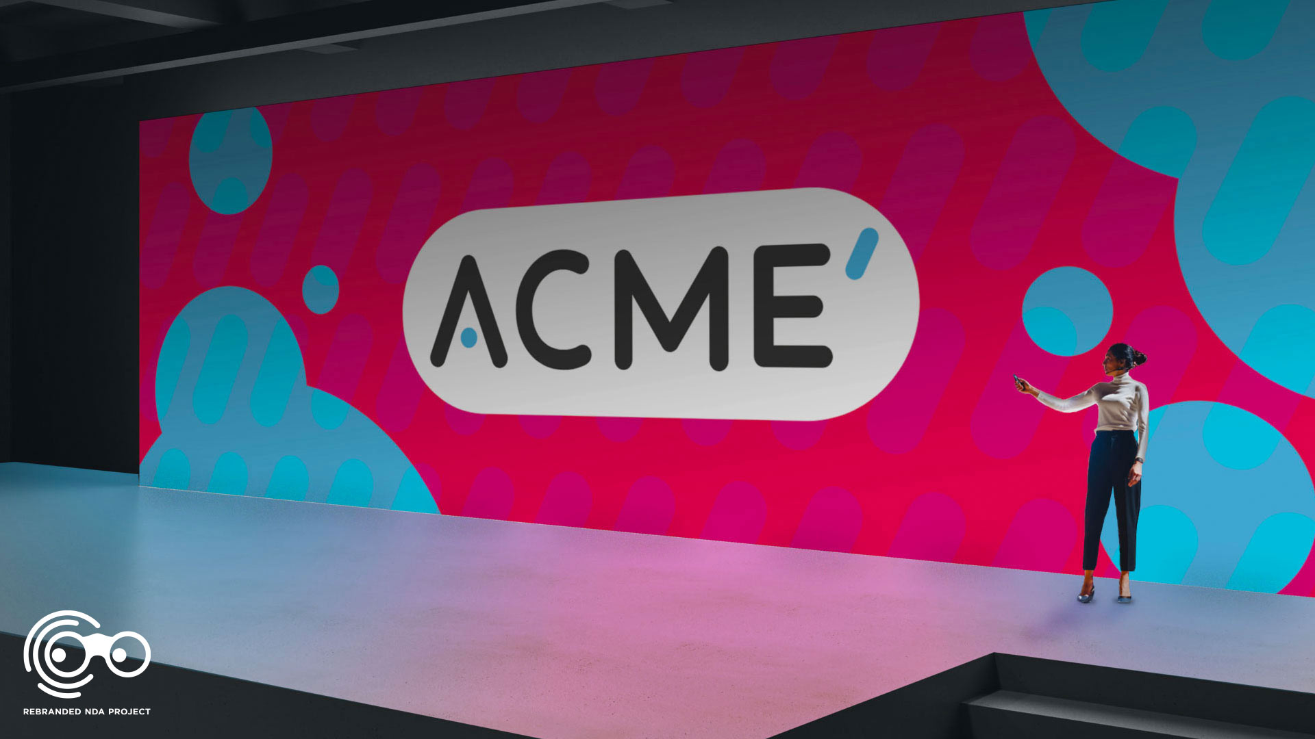 ACME Prime logo displayed on a large conference presentation screen with a business woman talking infront